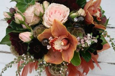 Cymbidium, chocolate cosmos, garden roses, scented geranium, jewels