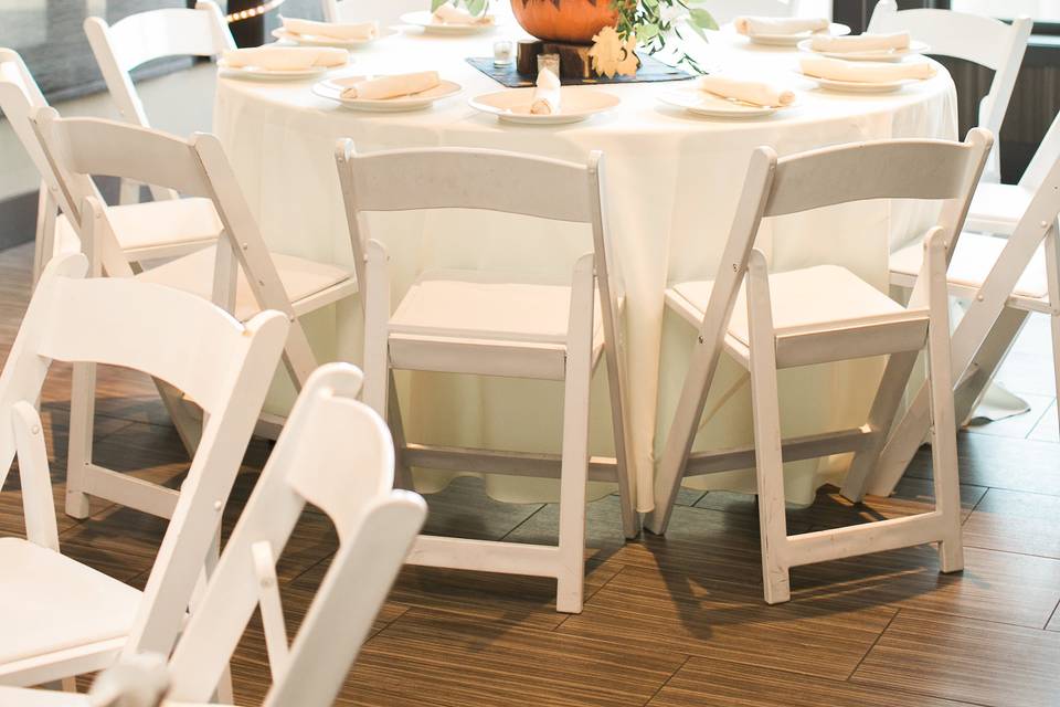 White chairs and ivory linens