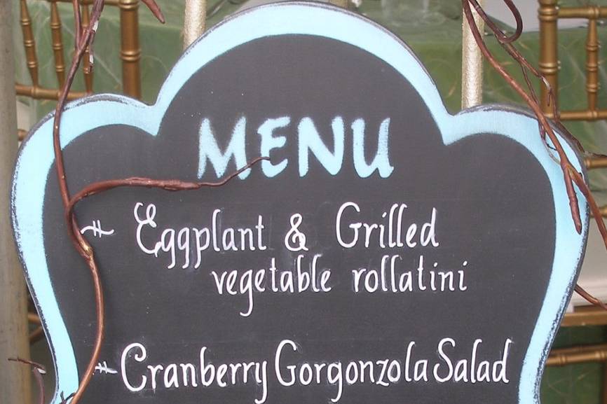 A menu board for a seaside wedding