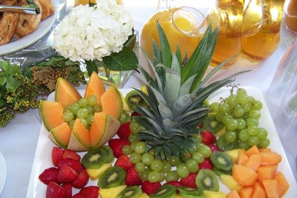 Summer Engagement Brunch  Fresh Fruit Display Featuring Carved Cantaloupe, Green Grapes, Sliced Strawberries, Kiwi and Pineapple
