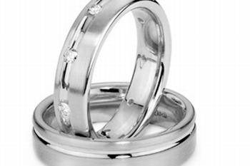 This stunning 14k white gold is and her wedding band looks even better by making adding two finishes to its look. With the ladies band set with round cut diamonds along a polished center. This comfort ring's polished edges combined with a brushed finish center makes this ring even more attractive.  Total weight of diamonds approximately 0.30 carats.