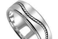 14k white gold handmade wedding band with satin finish and a wave-shaped woven design going all around the center with high polish edges.