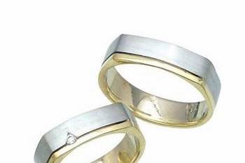 His and Hers handmade wedding bands is crafted in 14k two tone gold in a square shape exterior and rounded finish that will not pinch the skin and provides comfort fit. Her band includes a round cut diamond weighing approximately 0.05ct.