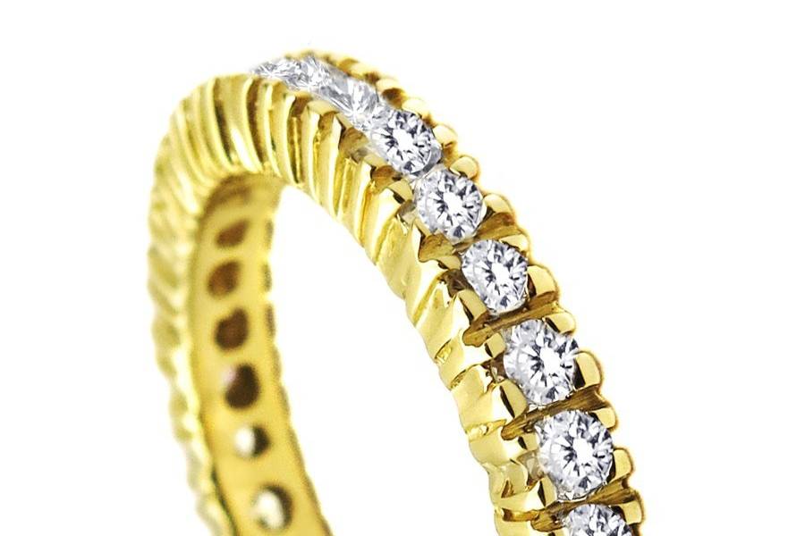 Marquise shape and Round Diamond Eternity Band in Bezel Setting. The band is shaped to encase each individual diamond for a unique design that is individual yet cooperative with an engagement ring. These brightly shining round diamonds are set in high polish 14k white gold weighing a total of approximately 0.50 carats.