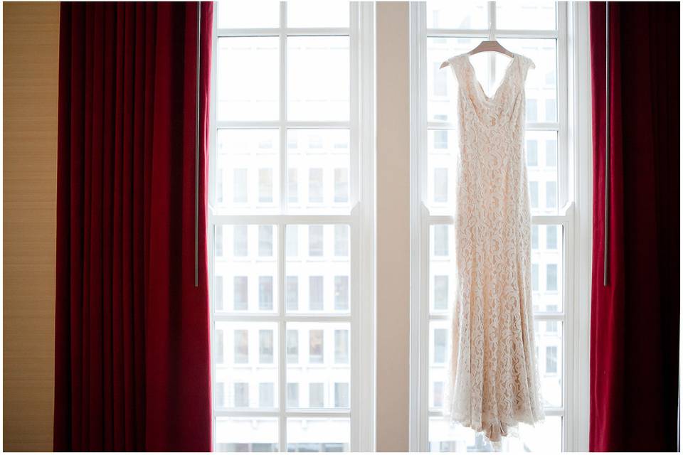 Wedding gown hanging in window