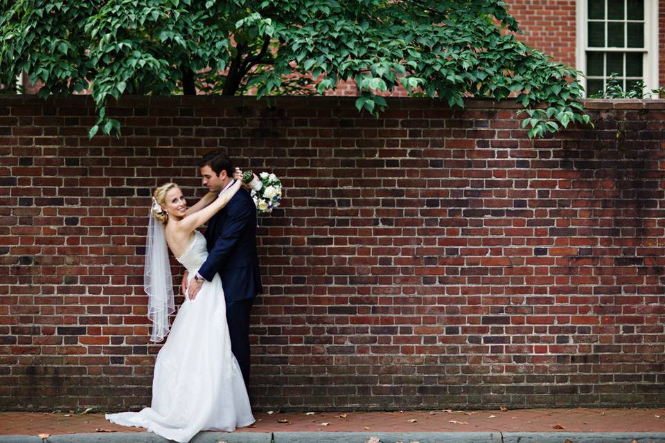 Couple portrait along brick wall