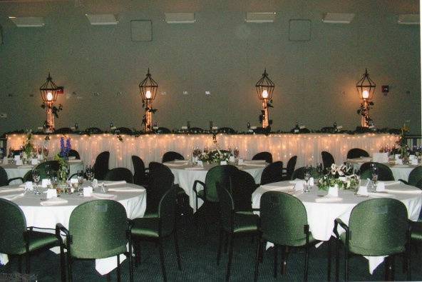 Head table on risers on floor of theater.