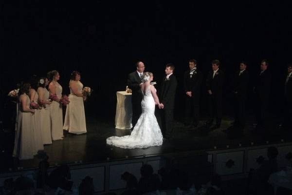 Bride and Groom on stage during wedding ceremony.