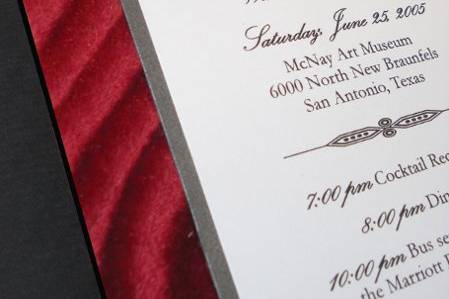 Black and white invite on red velvet board