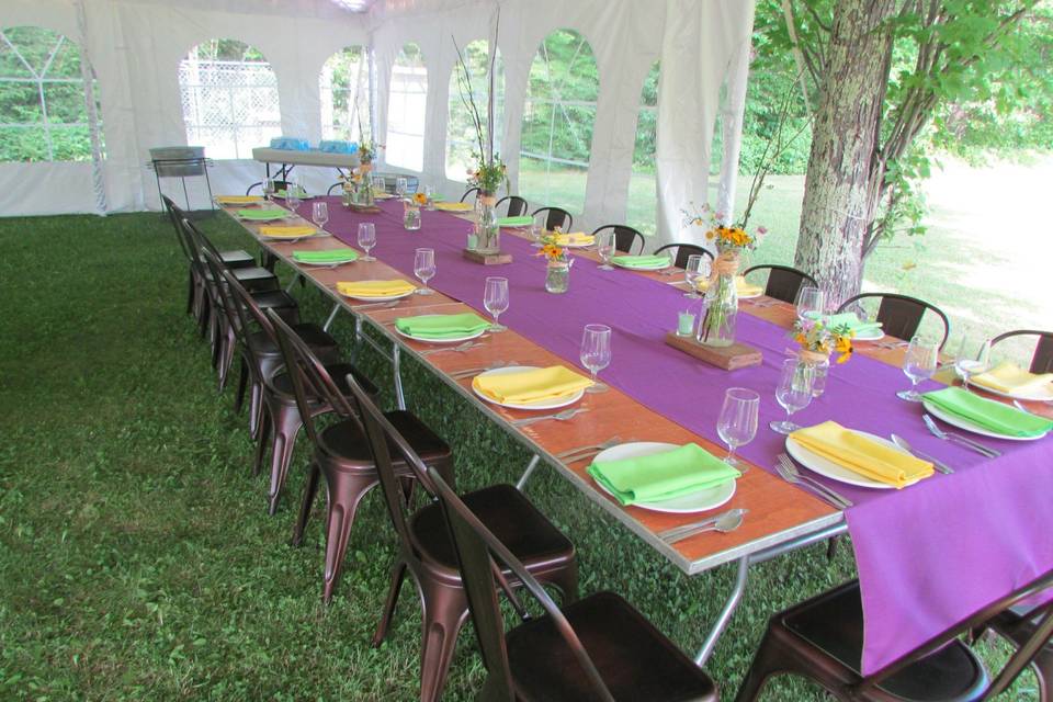 White ceremony chairs and tent