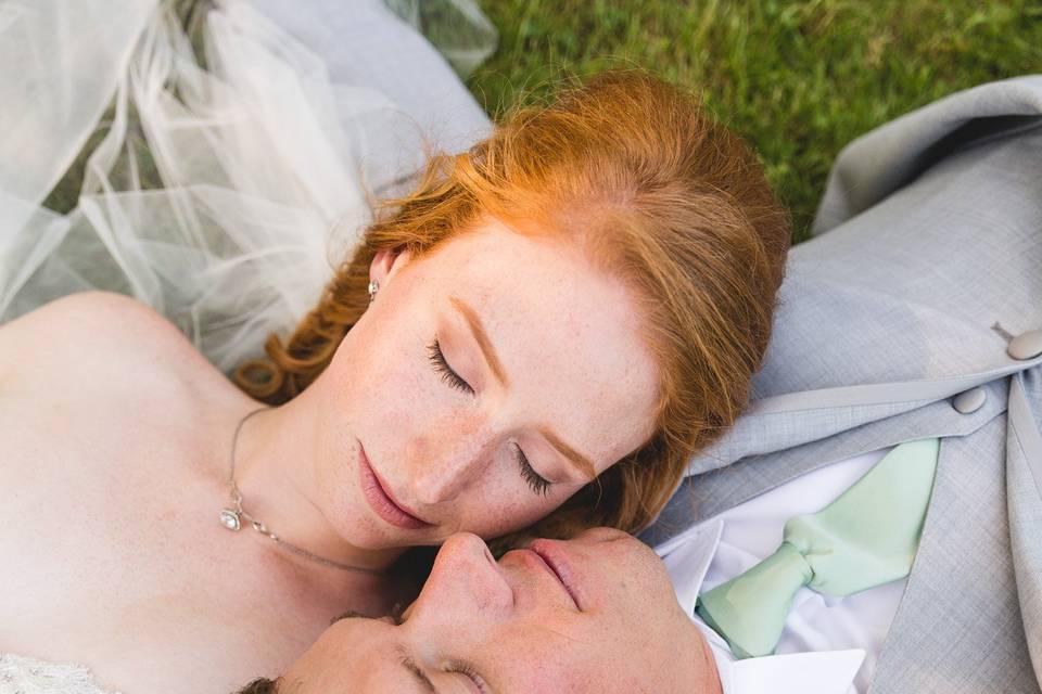 Couple lying in grass together