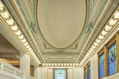 Elegant three-story lobby, with its original marble floor and Tiffany stained-glass windows
