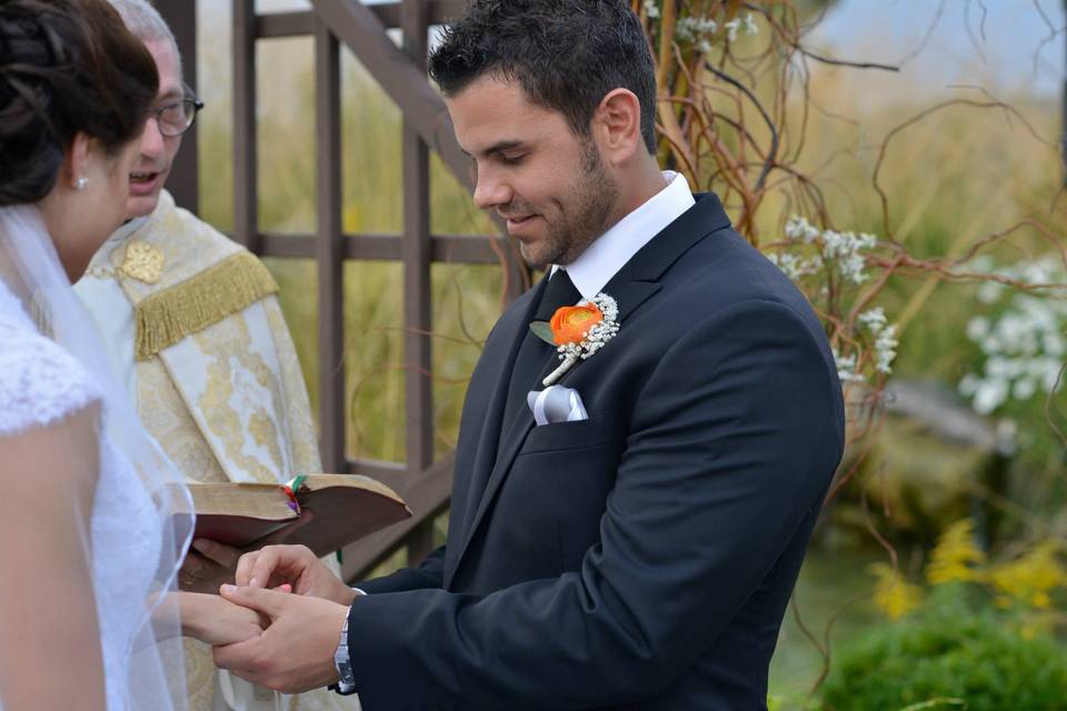 Placing the ring on bride's finger