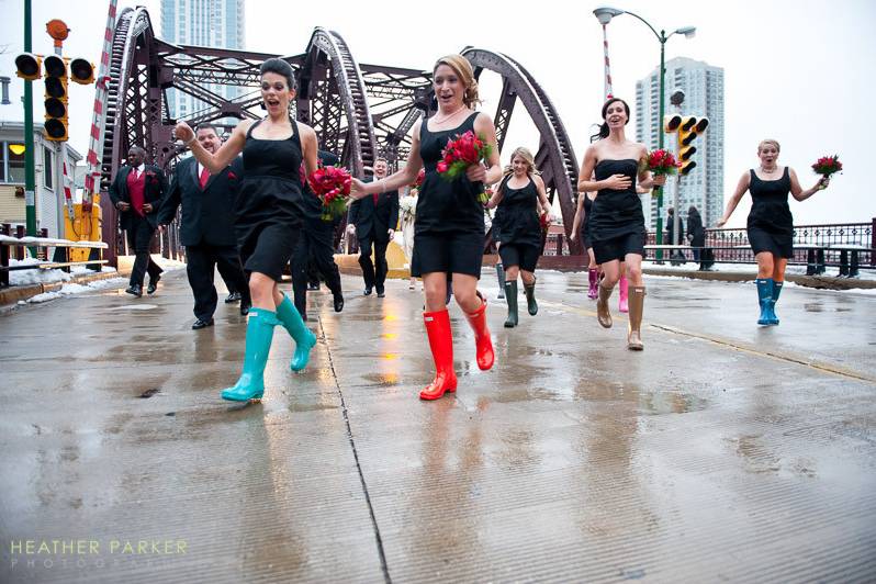 Bridesmaids dodge traffic after a group shot during this InterContinental Hotel  Holy Name wedding during the winter.