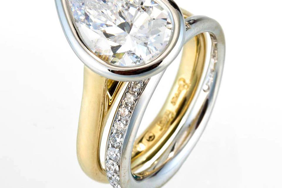 Pear shape diamond engagement ring with diamond channel wedding band in 18kt gold & platinum