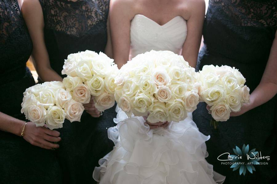 The bride holding her bouquet with her bridesmaid