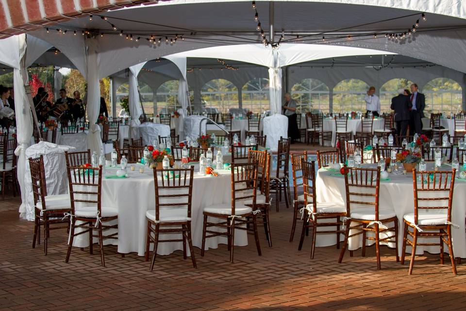 12 person head table on risers with ivory lamour satin gathered skirting with brooches