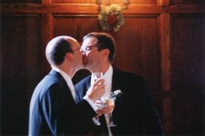 Gay couple kissing at their wedding.