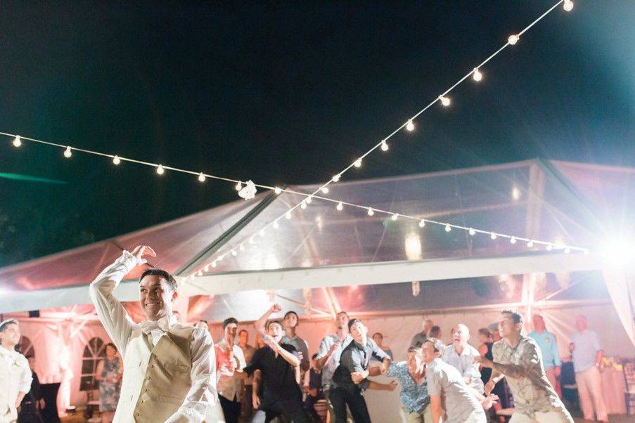 Groom tossing garter