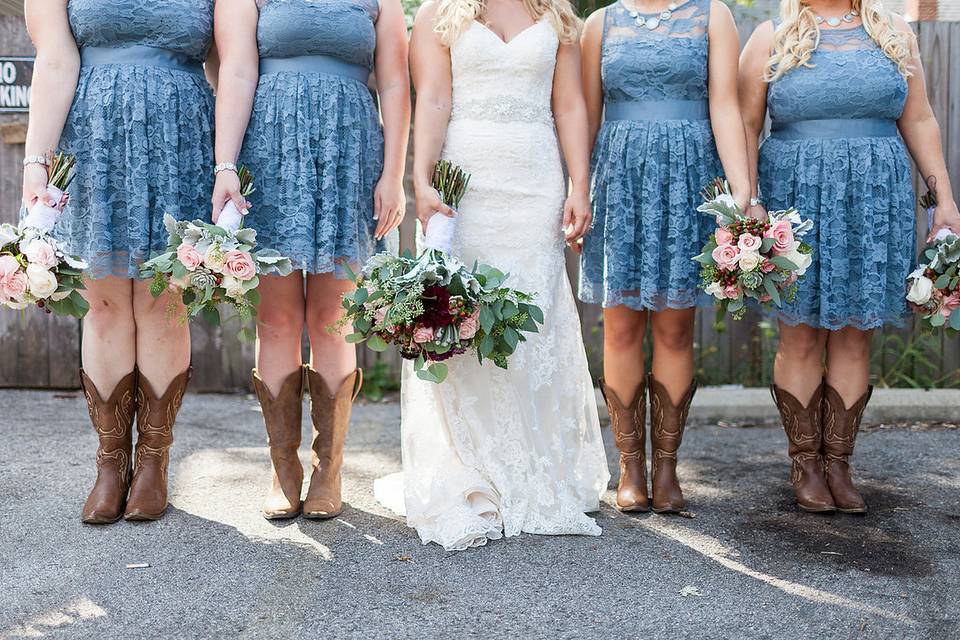 The bride and her bridesmaids holding their bouquet