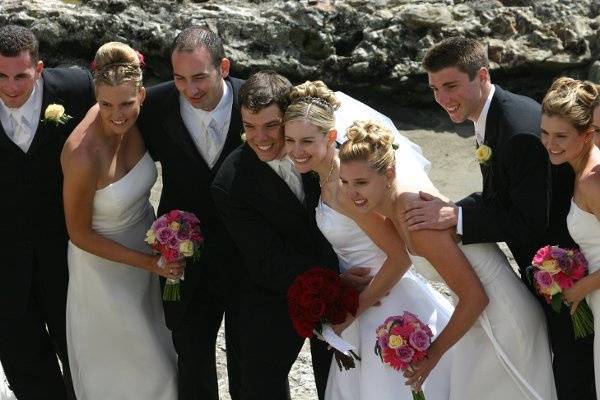 Destinations wedding.  Bridal party with bouquets made of pinks and purples.