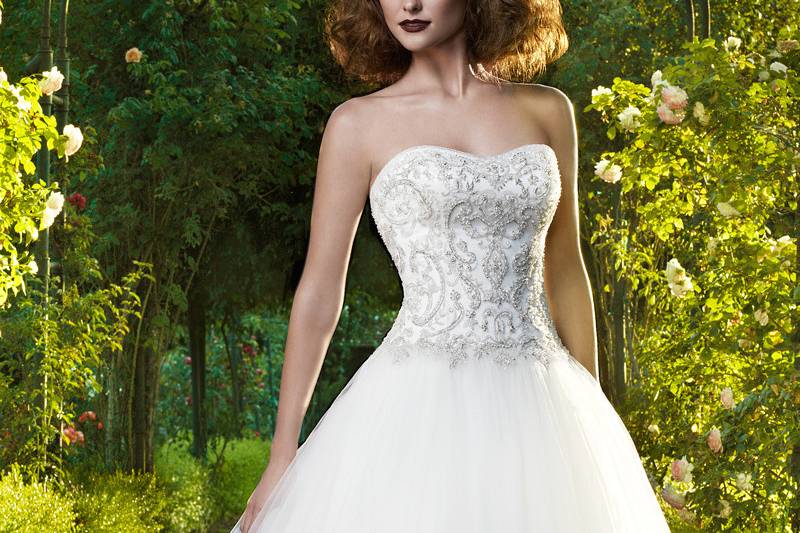 Style 2125
This versatile gown can be worn with the detachable, sheer short sleeve bolero jacket or worn without for a strapless sweetheart look. The bodice has Gossamer Chantilly Lace under finely ruched Soft Tulle. Fitted A-line skirt has a layer of Gossamer Chantilly Lace with an overlay of beaded lace that flows into a heavily beaded scalloped hem.
