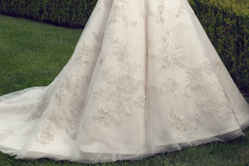 an overlay of Soft Tulle and crystal buttons along the zipper finish the haute look of this gown.