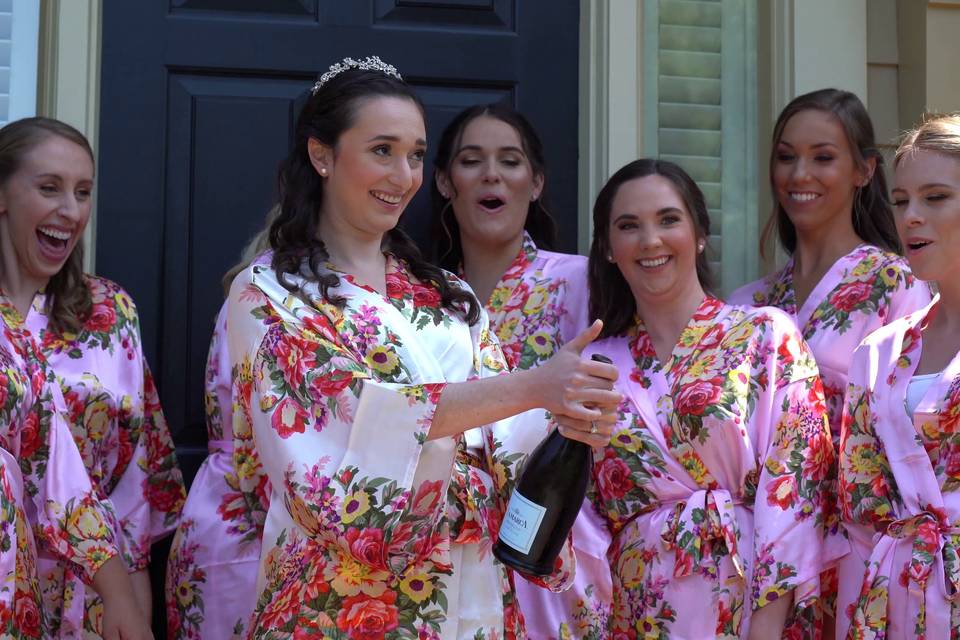 Bridesmaids pop champagne