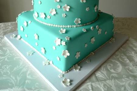 Tiffany blue cake adorned with white blossoms