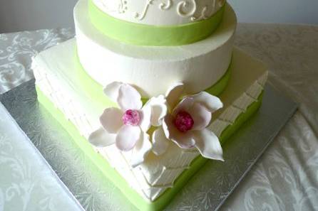 Ivory buttercream cake with green and magenta accents