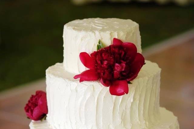 White wedding cake with red roses