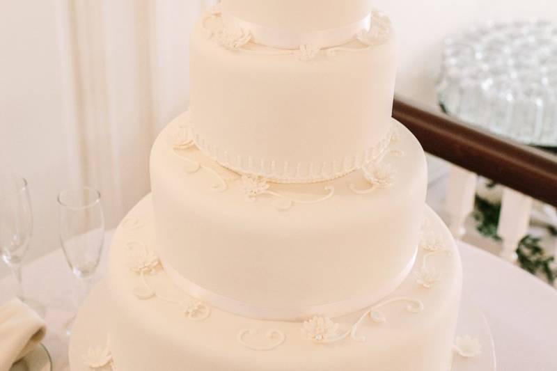 White wedding cake with figurines on top