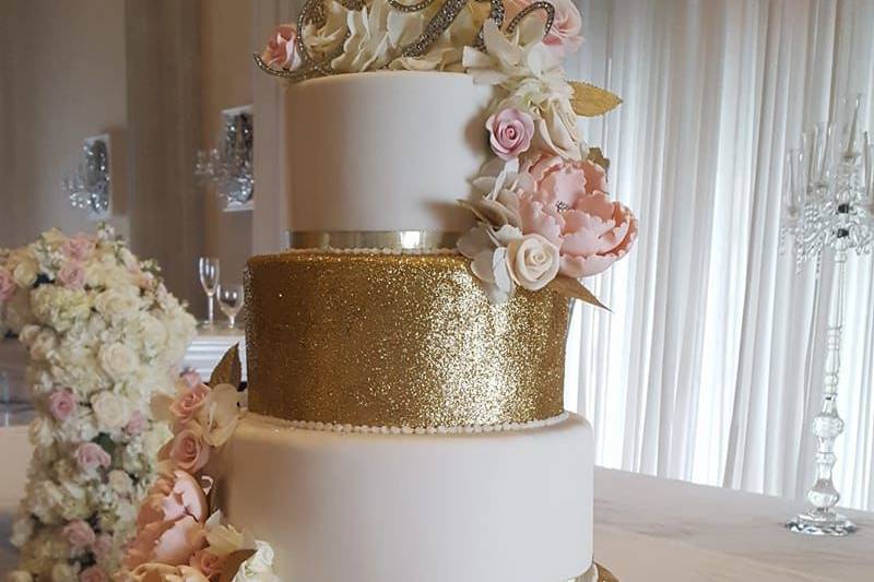 Lavish gold and blush ruffled 5 tiered wedding cake with all hand sculpted rhinestone centered peonies and roses