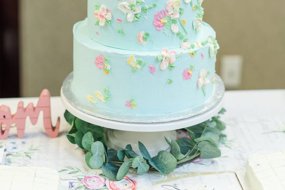 Elegant white fondant cake with luster leaves and silver dragees with red borde