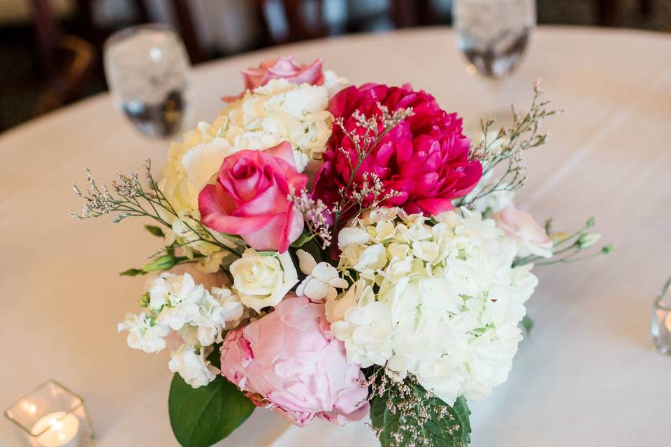 Hydrangeas, roses and peonies complete the centerpieces