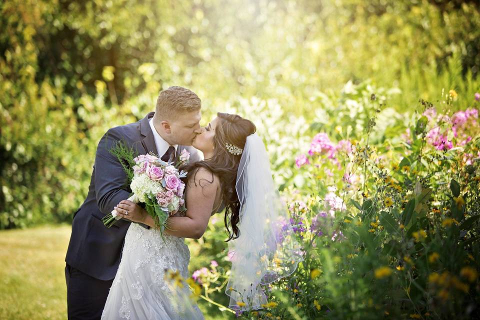 Couple kiss on groomed grounds