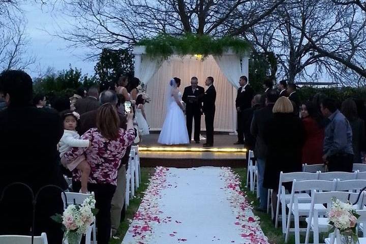 Outdoor wedding with pink petals