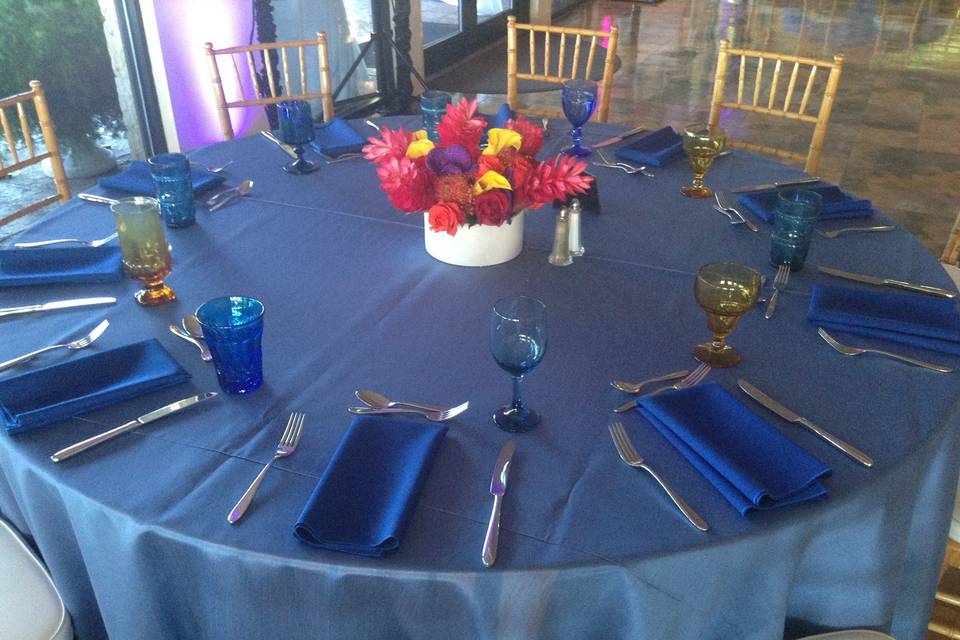 Blue table setting with bright flowers