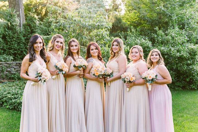 Bride's gown pulled by her groom and bridesmaid