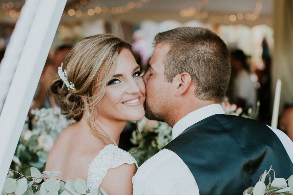 Groom kissing his bride