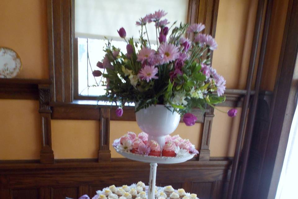A darling display with our take on a cupcake stand, using a vintage inspired 2 tier table that is perfect for displaying cupcakes and desserts in a delightfully fun way.  This reception was at the Turner Dodge House in Lansing.