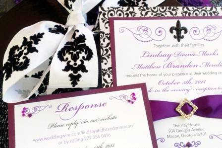 Custom Musical Wedding Invitation - this elegant invitation features purple and black brocade accents for an elegant old world feeling. The invitation has 3D Fleur di lis and the backing paper is a glitter brocade. There is a purple ribbon with crystal buckle. The black box has a velvet and satin wire ribbon with black brocade on it. Suite comes with an RSVP card, envelope and choice of music!