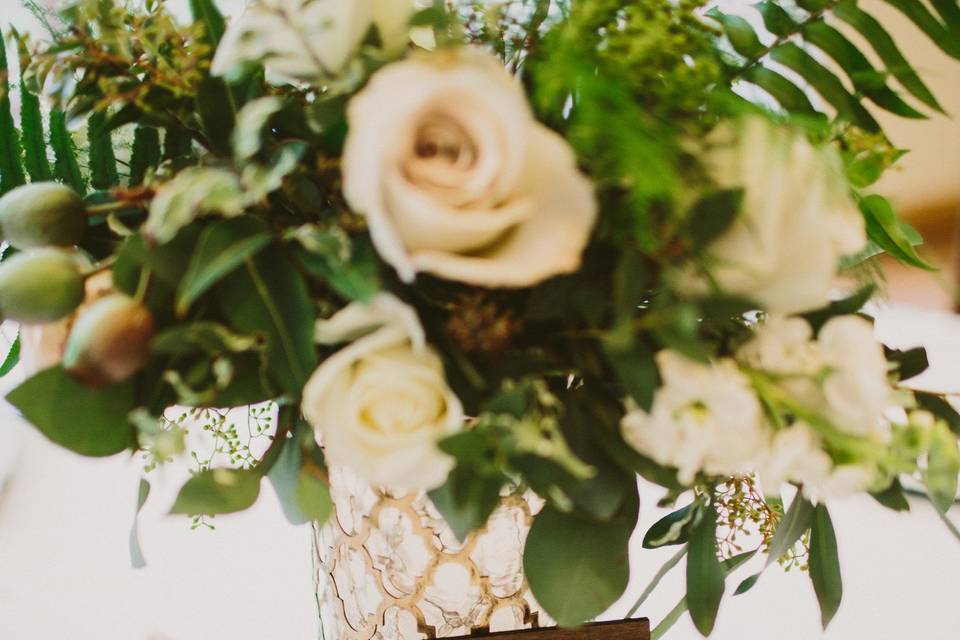 Creams and greens centerpieces, lush winter garden vibes in gold vase.