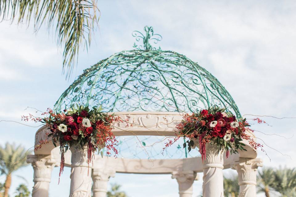 Wild greenery, orchids, and burgundy vibes for this Arbor piece.