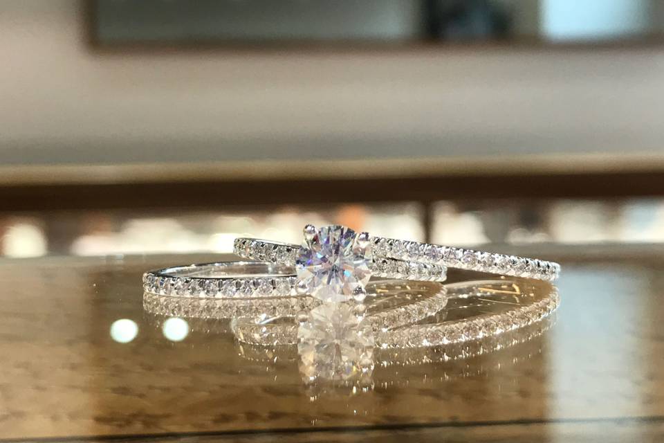 Custom Design, Classic prong set diamond engagement ring with a round center and two matching diamond bands that flawlessly blend together.