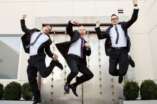 Jumps shot of the groom and groomsmen