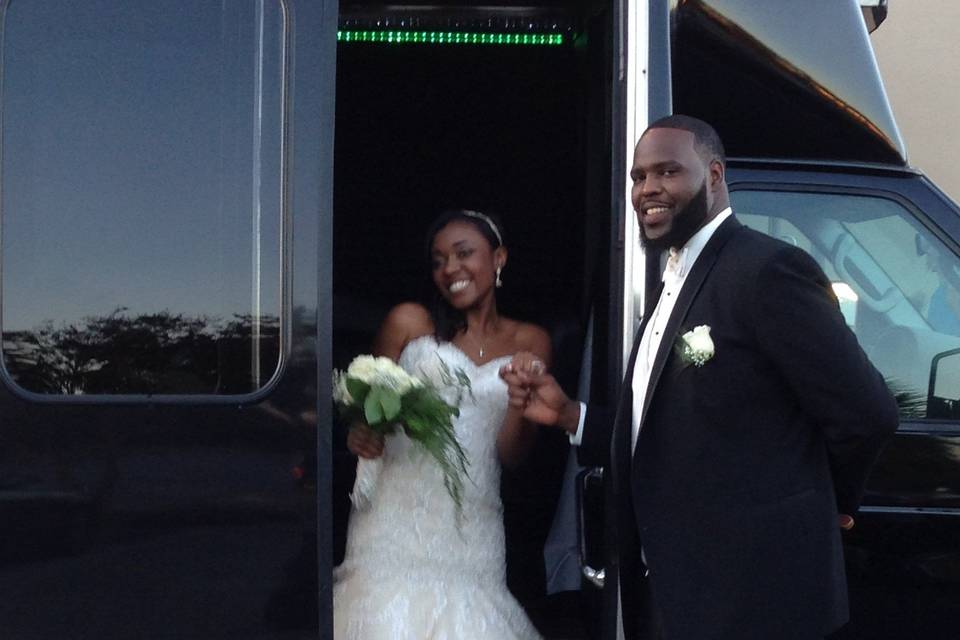 Bride and Groom Getting Off The Limo Bus, Ready To Make That Grand Entrance