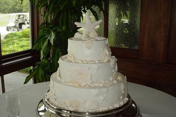 Wedding cake: Buttercream cake accented with fondant sea shells. Reception held at Brunswick Country Club.