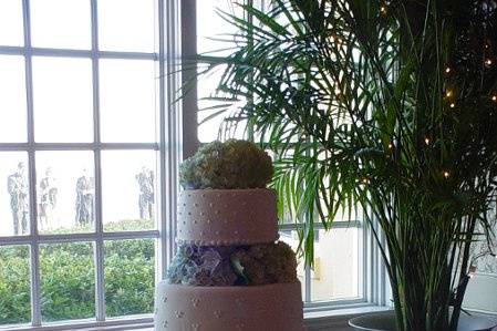 Three tiered buttercream with columns and designs, accented with hydrangeas. Reception held at King and Prince Resort St. Simons Island, Ga.