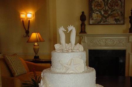 Three tier buttercream with sparkling sugar crystals, accented with shells and seahorses. Reception held at King and Prince Resort on St. Simons Island, Ga.